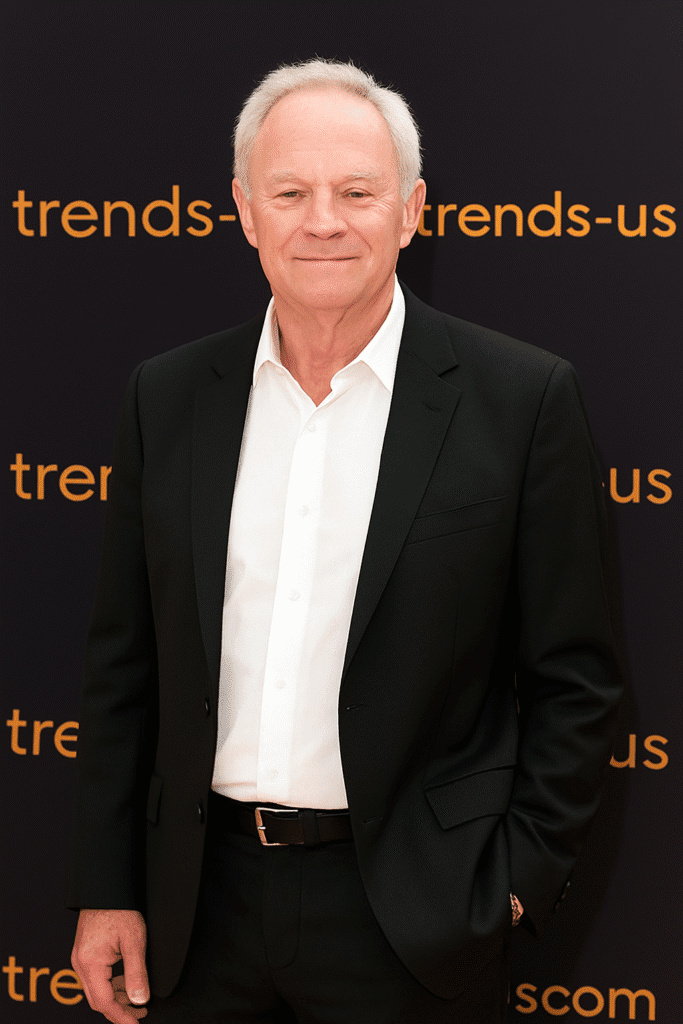 Tristan Rogers, best known as Robert Scorpio from General Hospital, smiling in a black suit during a public appearance